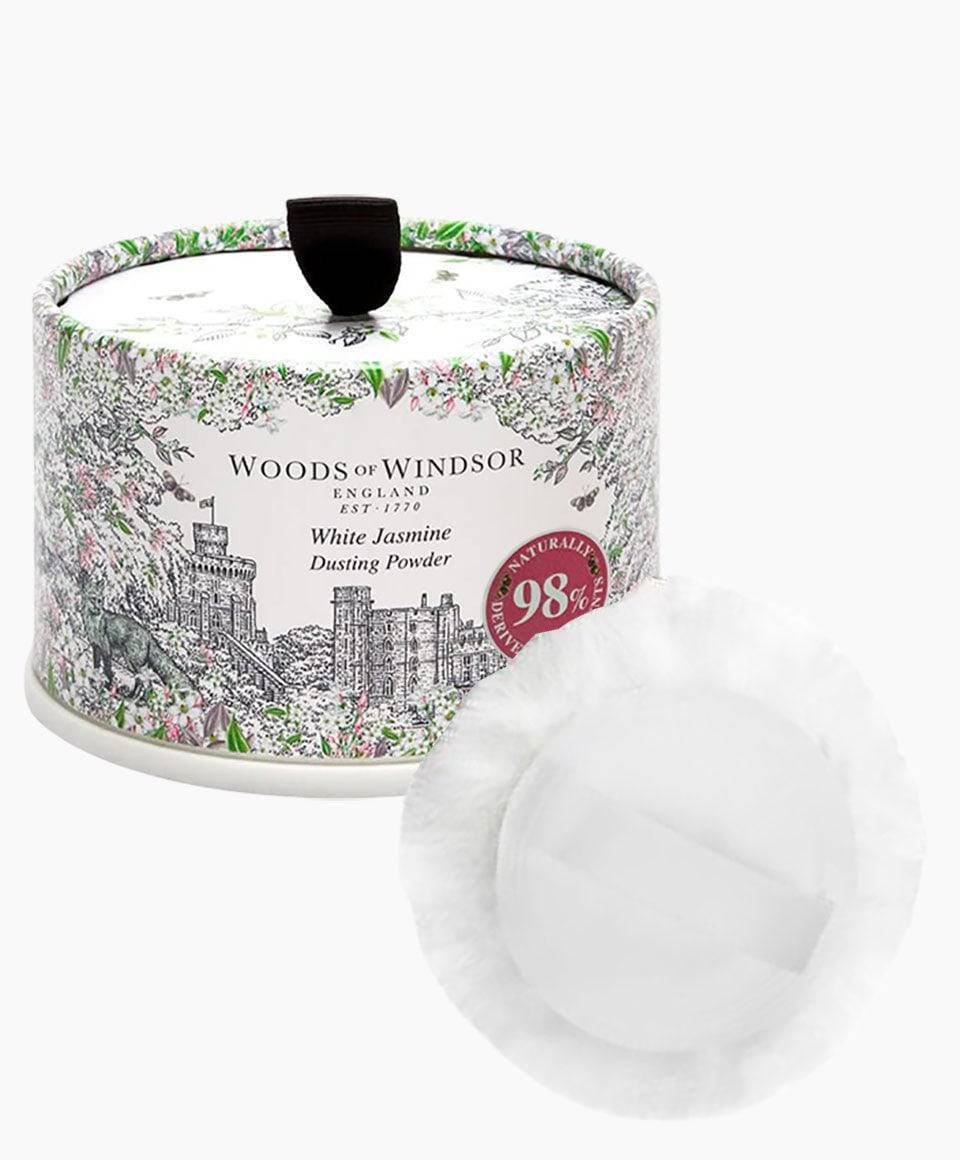 White Jasmine Woods Of Windsor face dusting powder in a jar, with a white floral-scented face powder and elegant packaging.