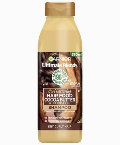 Garnier Ultimate Blends Cocoa Butter Hair Food curl restoring shampoo bottle with labels and product details.