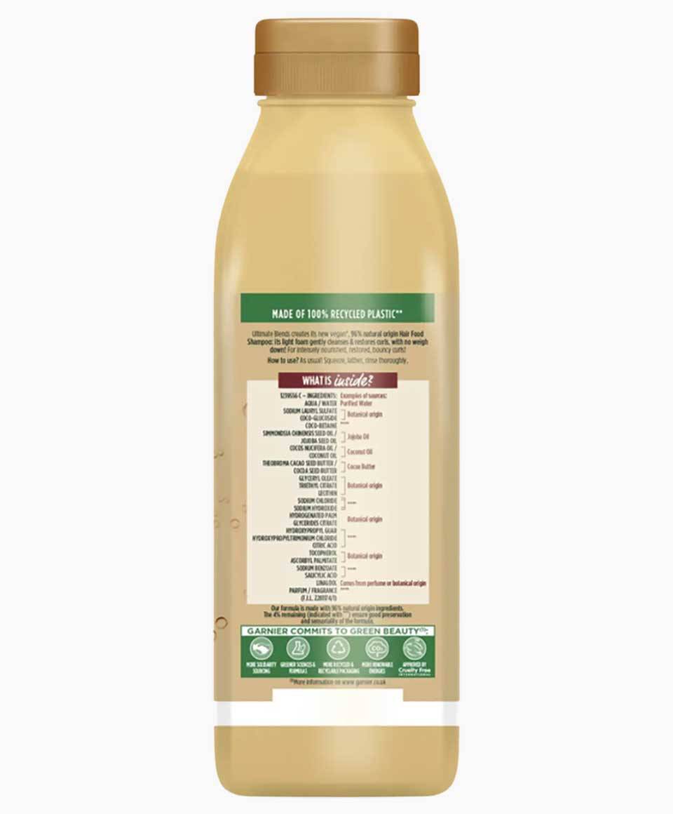 Garnier Ultimate Blends Cocoa Butter Hair Food curl restoring shampoo bottle with label and pump dispenser on a white background