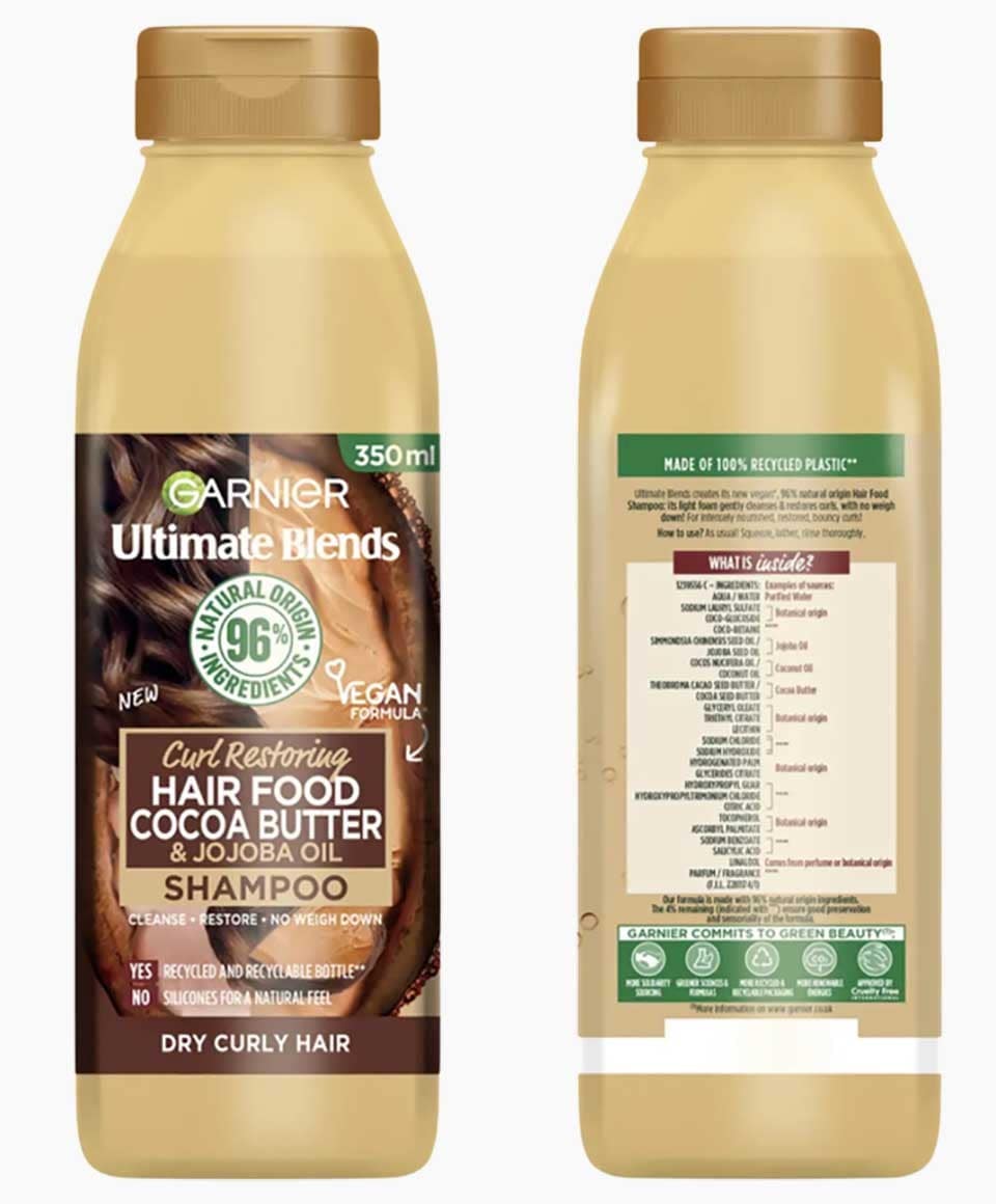 Garnier Ultimate Blends Cocoa Butter Hair Food curl restoring shampoo bottle with label and cap, designed for nourishing curly hair.