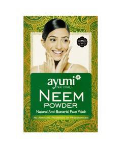Ayumi Naturals Neem Powder for skin soothing, displayed in a clear glass jar with a scoop beside it, set against a natural background.