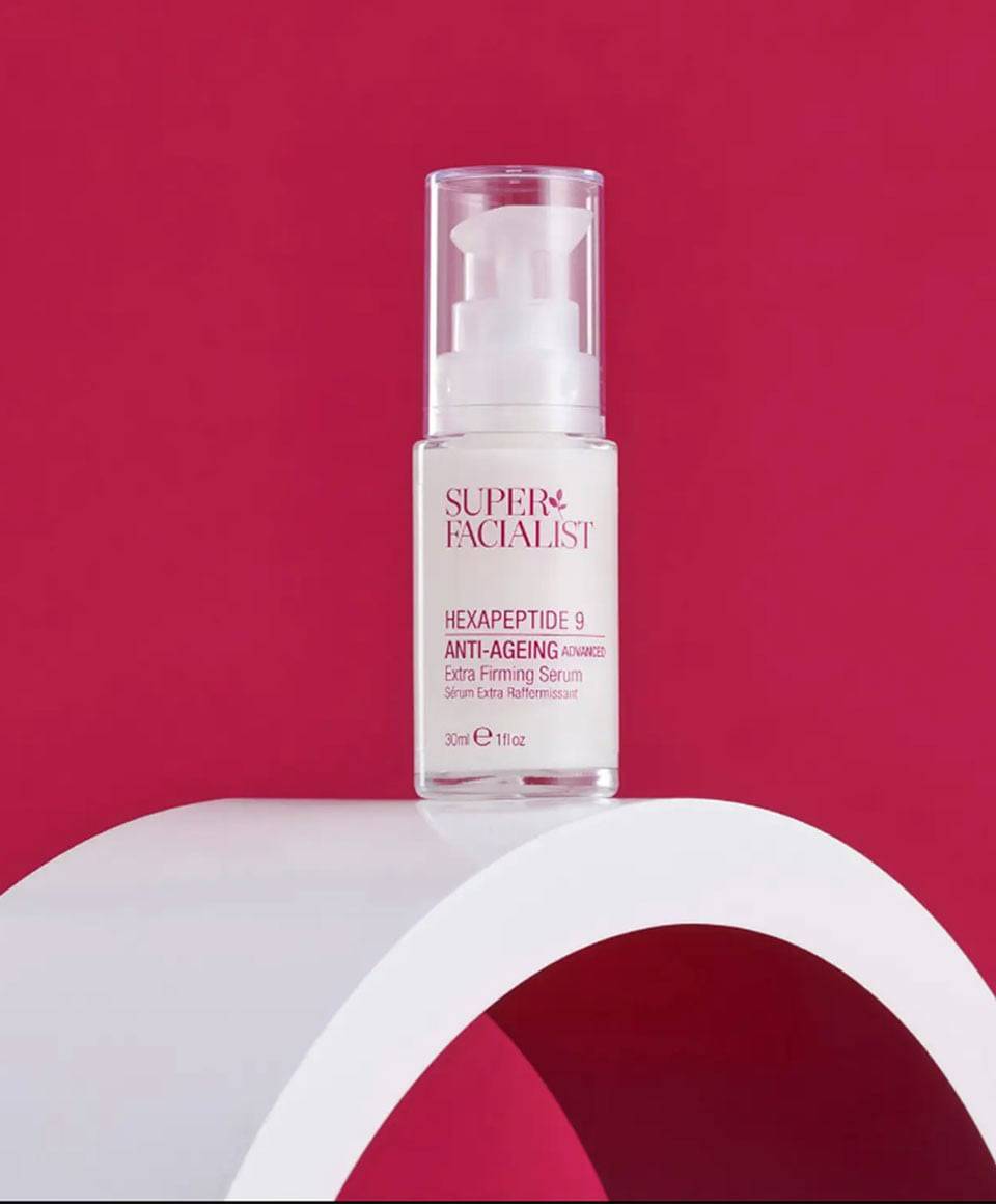 Super Facialist Hexapeptide 9 Anti-Ageing Extra Firming Serum moisturizer in a sleek bottle with a white pump dispenser.