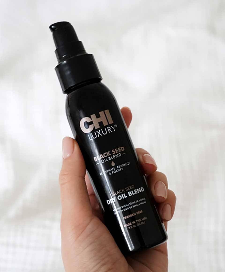 Farouk Systems CHI Luxury Black Seed Oil Blend dry hair treatment bottle with black and gold label.