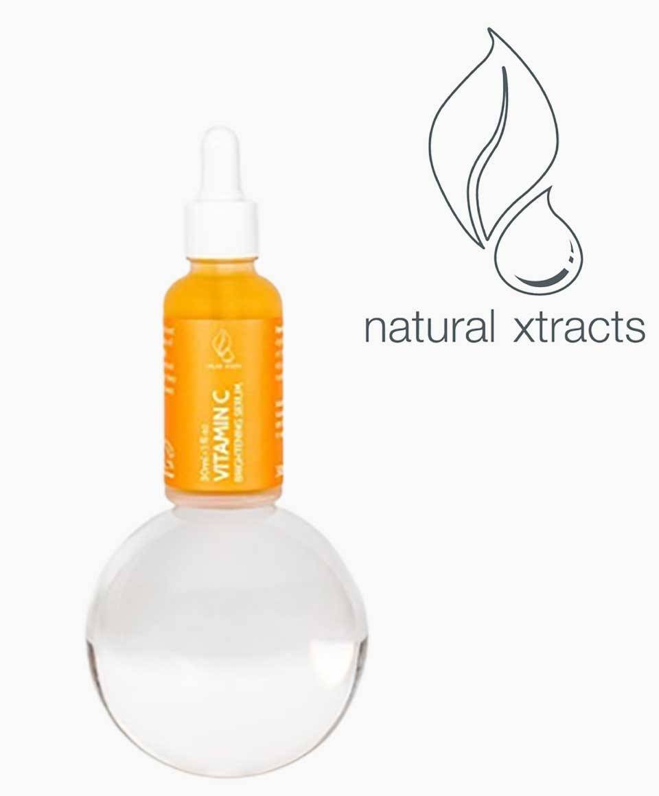Natural Xtracts Vitamin C Serum bottle for skin soothing, with a clear dropper and fresh citrus slices in the background.