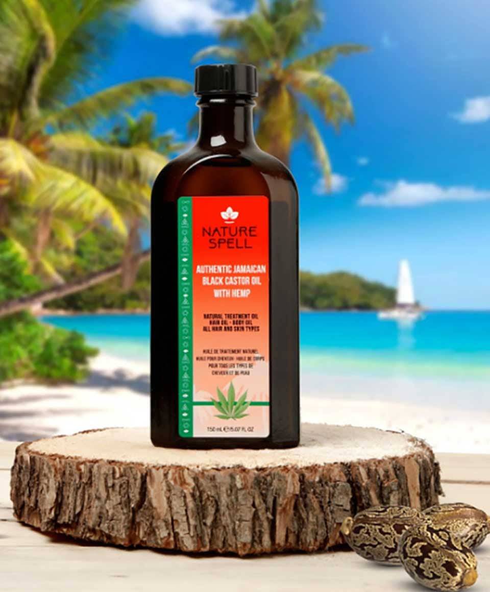 Bottle of Nature Spell Jamaican Black Castor Oil with hemp for hair treatment, dark glass container with label, on a white background.