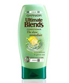 Garnier Ultimate Blends Shine Revitaliser Conditioner bottle with label and pump dispenser on a white background.