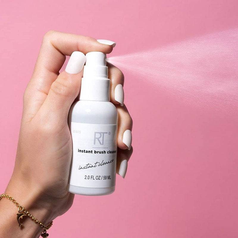 Real Techniques Instant Brush Cleaner bottle, salon accessory for quick makeup brush cleaning, with a clear label and pump dispenser.