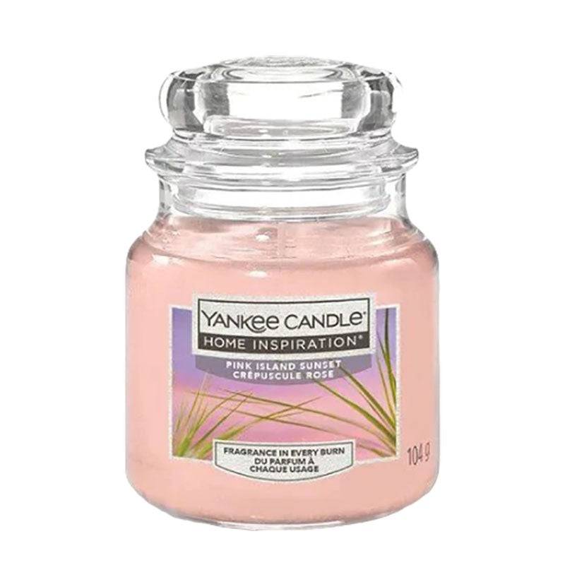 Yankee Candle Pink Island Sunset home fragrance in a jar, with a pink and sunset-themed label, designed to freshen and decorate space.