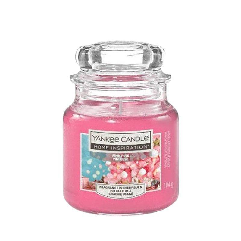 Yankee Candle Pink Pine home fragrance with pink wax and pine scent in a glass jar, ideal for adding a fresh, cozy aroma to your space.