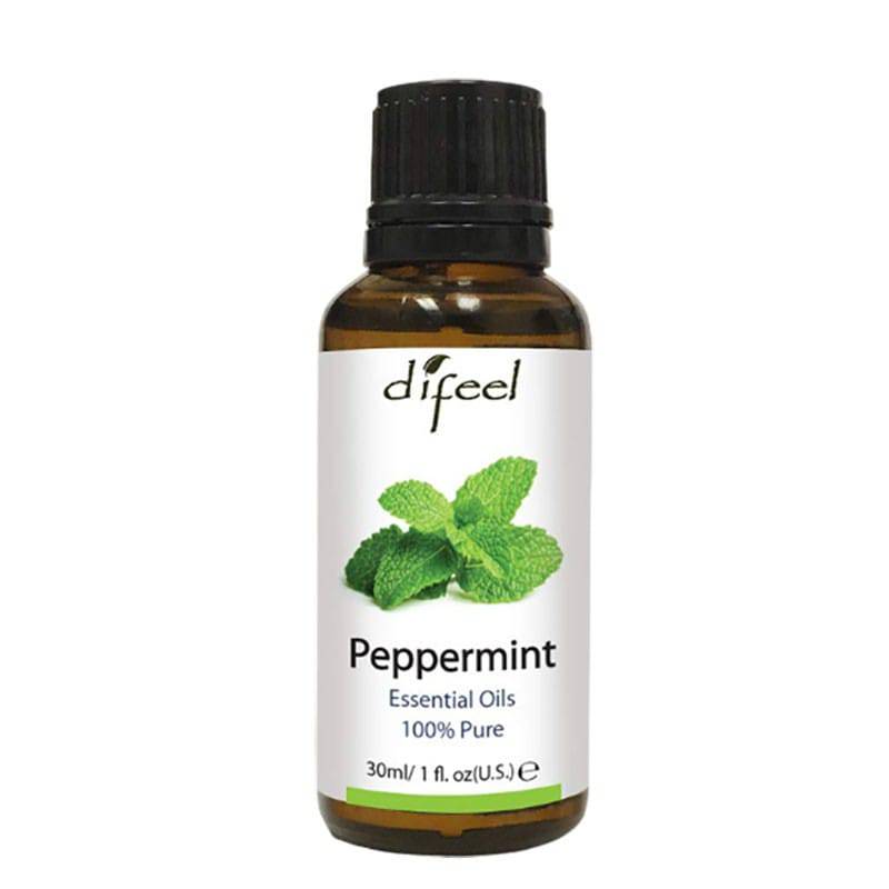 Difeel Peppermint Essential Oil for hair treatment, with fresh peppermint leaves and a glass bottle on a white background.