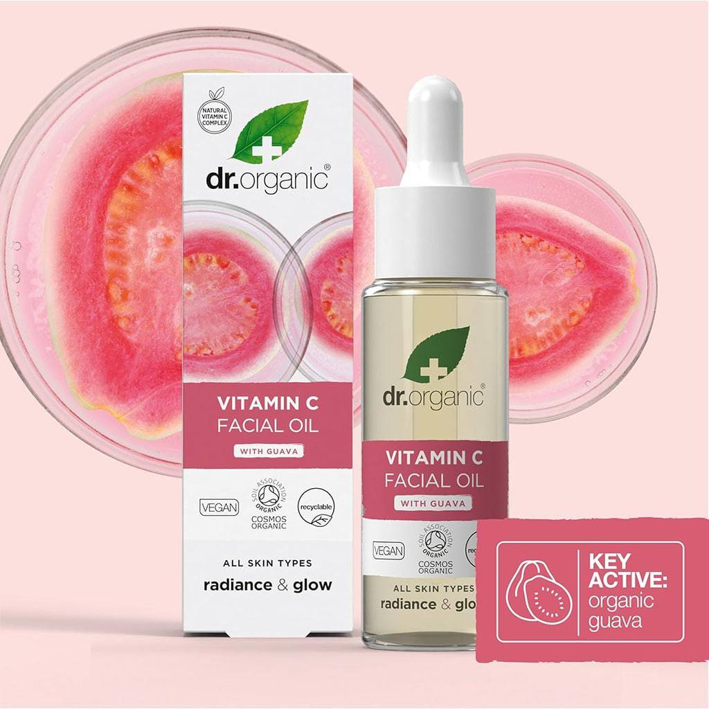 Dr Organic Organic Guava Brightening Facial Serum in a dropper bottle with a fresh guava backdrop.