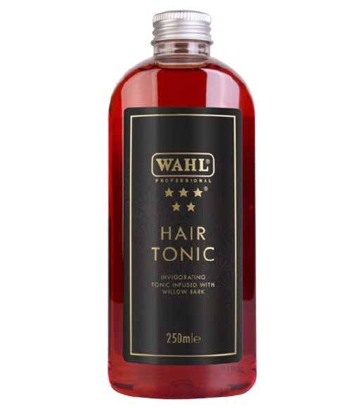 Wahl Traditional Shaving Range Hair Tonic bottle with a sleek design on a wooden surface, showcasing its rich color.
