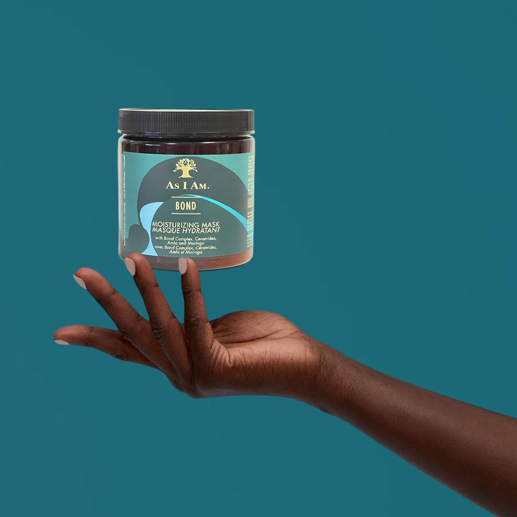 Cream-colored jar of As I Am Bond Moisturizing Hair Mask, showing the hair treatment product with label visible.