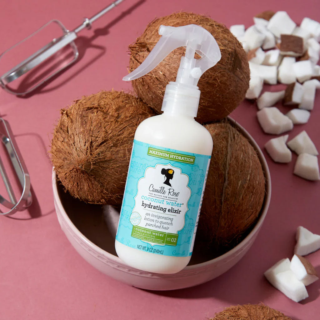 Camille Rose Naturals Coconut Water Hydrating Elixir hair treatment bottle with coconut water and natural ingredients.