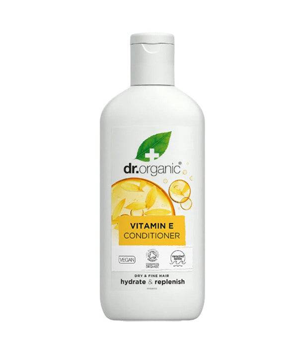 Dr Organic Hydrate and Replenish Vitamin E Conditioner in a bottle with a pump dispenser, designed for nourishing hair.