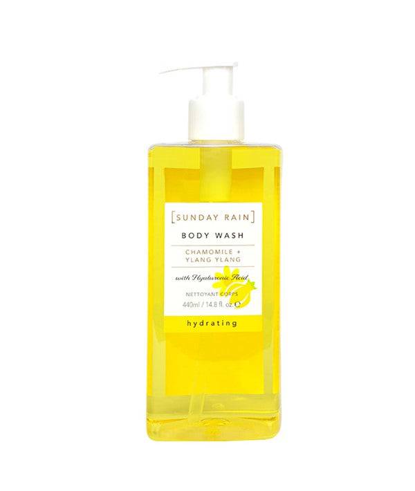 Sunday Rain Chamomile Ylang Ylang body wash in a clear bottle, with botanical ingredients and a floral, relaxing scent.