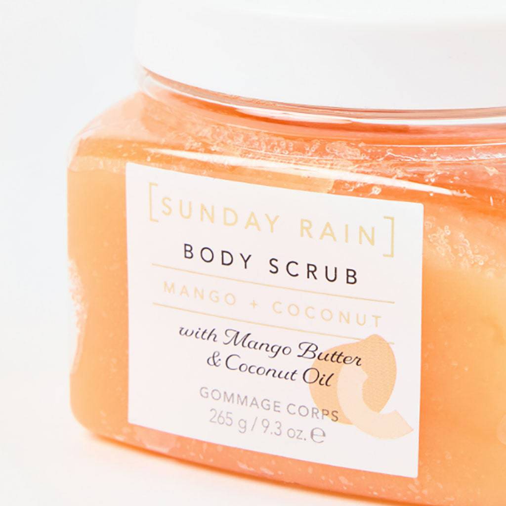 Sunday Rain Mango and Coconut Body Scrub in a jar, showcasing the bath and shower exfoliating product with fresh mango and coconut ingredients.