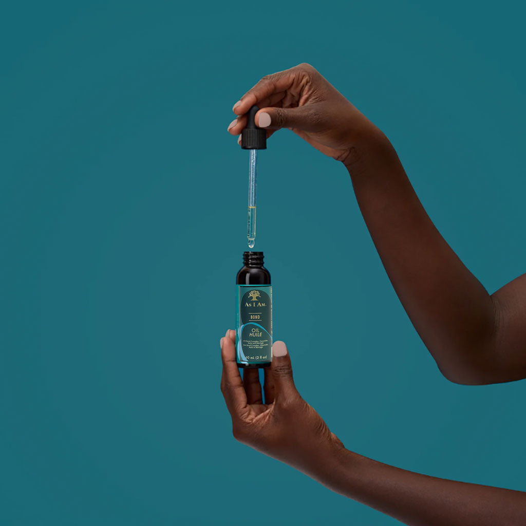 Bottle of As I Am Bond Hair Oil, a nourishing hair serum with a clear liquid inside a sleek bottle, for strengthening and conditioning hair.