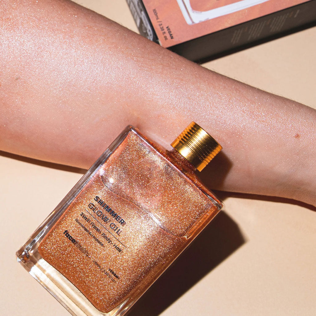 Face Facts 3-in-1 shimmer glow oil for body care, featuring a sparkling, luminous finish on the skin.