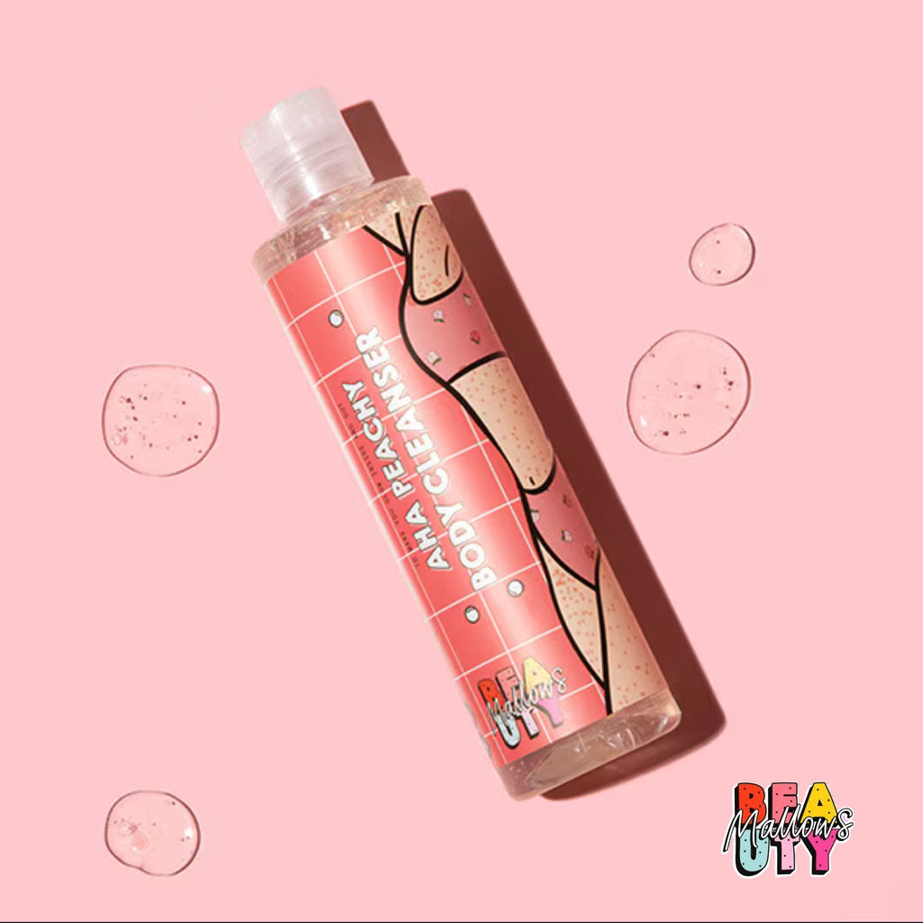 Mallows Beauty Peachy AHA Body Cleanser in a pump bottle for bath and shower use, featuring peach and exfoliating ingredients.