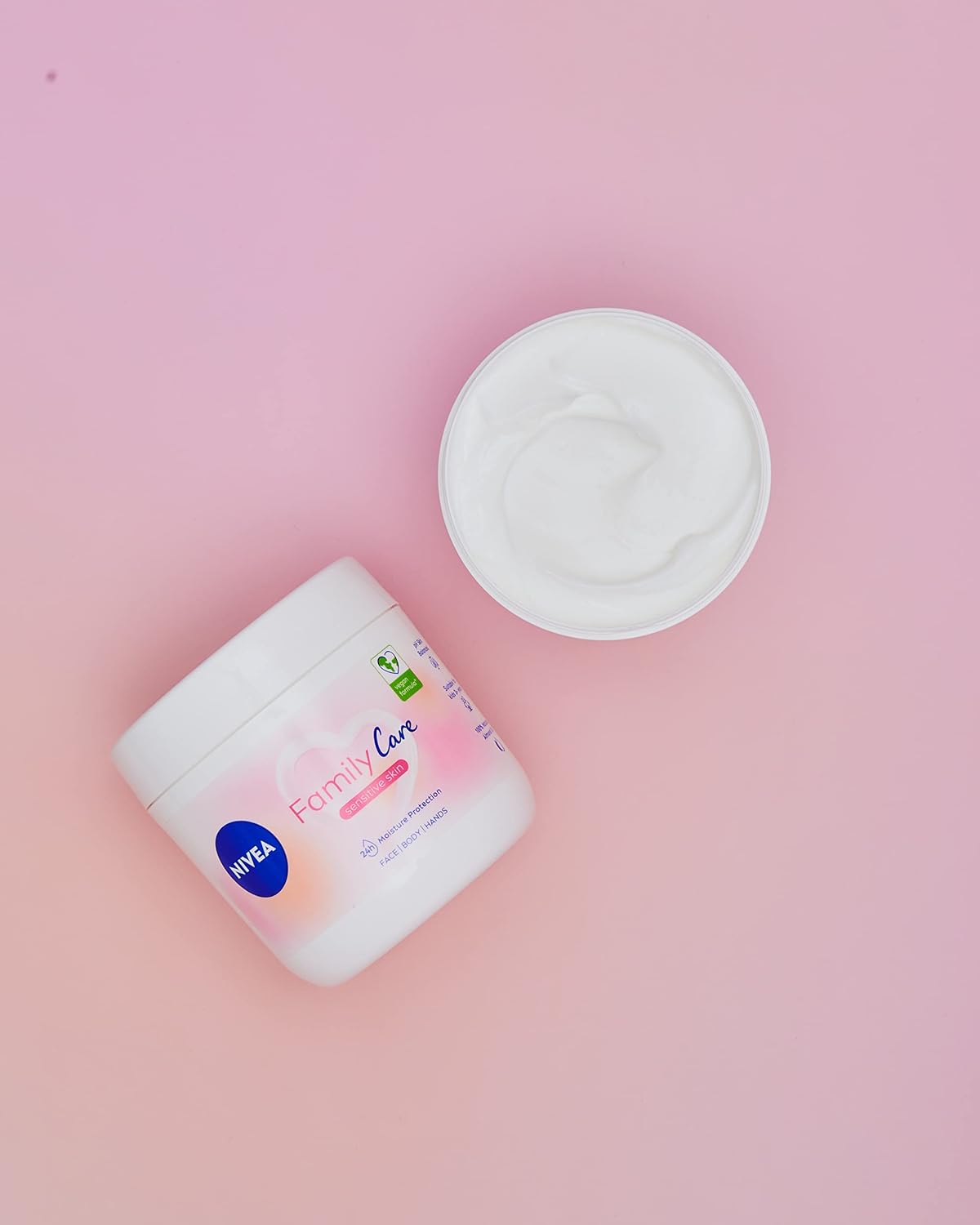 Nivea Family Care Moisturising Cream jar with blue lid, creamy texture, and Nivea branding on the label.