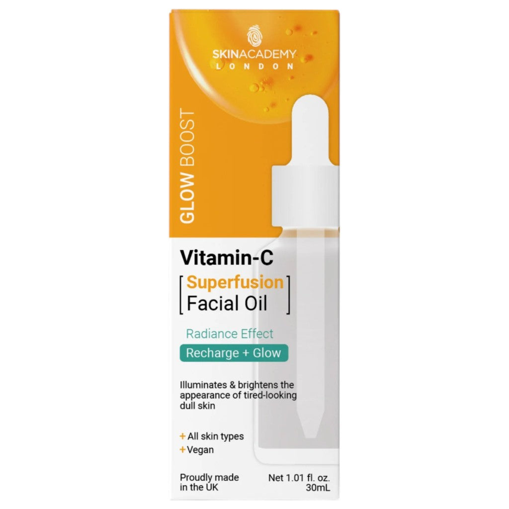 Skin Academy Glow Boost Vitamin C facial oil in a 30ml bottle, featuring a clear container with a dropper cap and bright orange liquid.