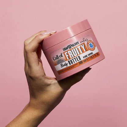 Soap and Glory Call of Fruity Body Butter jar with vibrant label, creamy texture, and fresh fruit scent for nourishing skin.