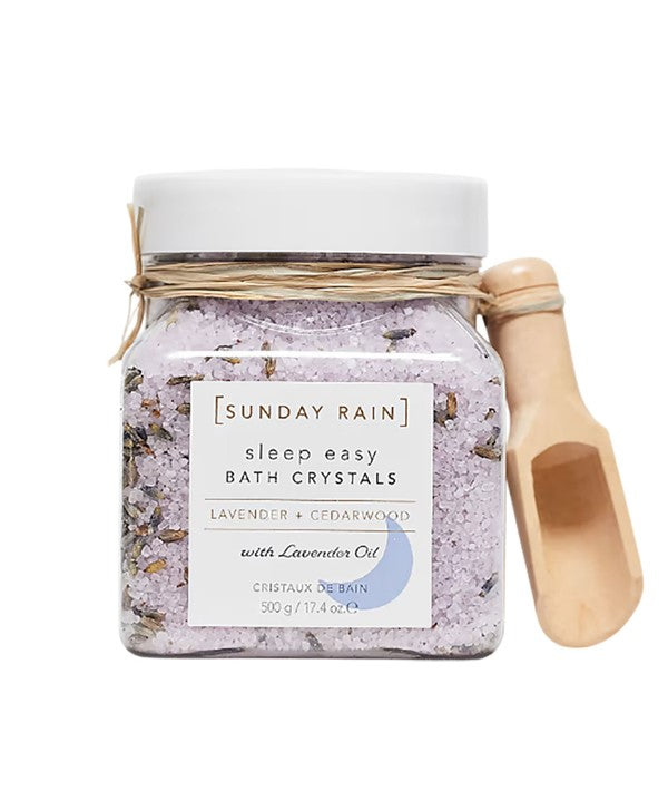 Sunday Rain lavender and cedarwood sleep easy bath crystals in a clear jar with a lavender and cedarwood scent for relaxing bath time.