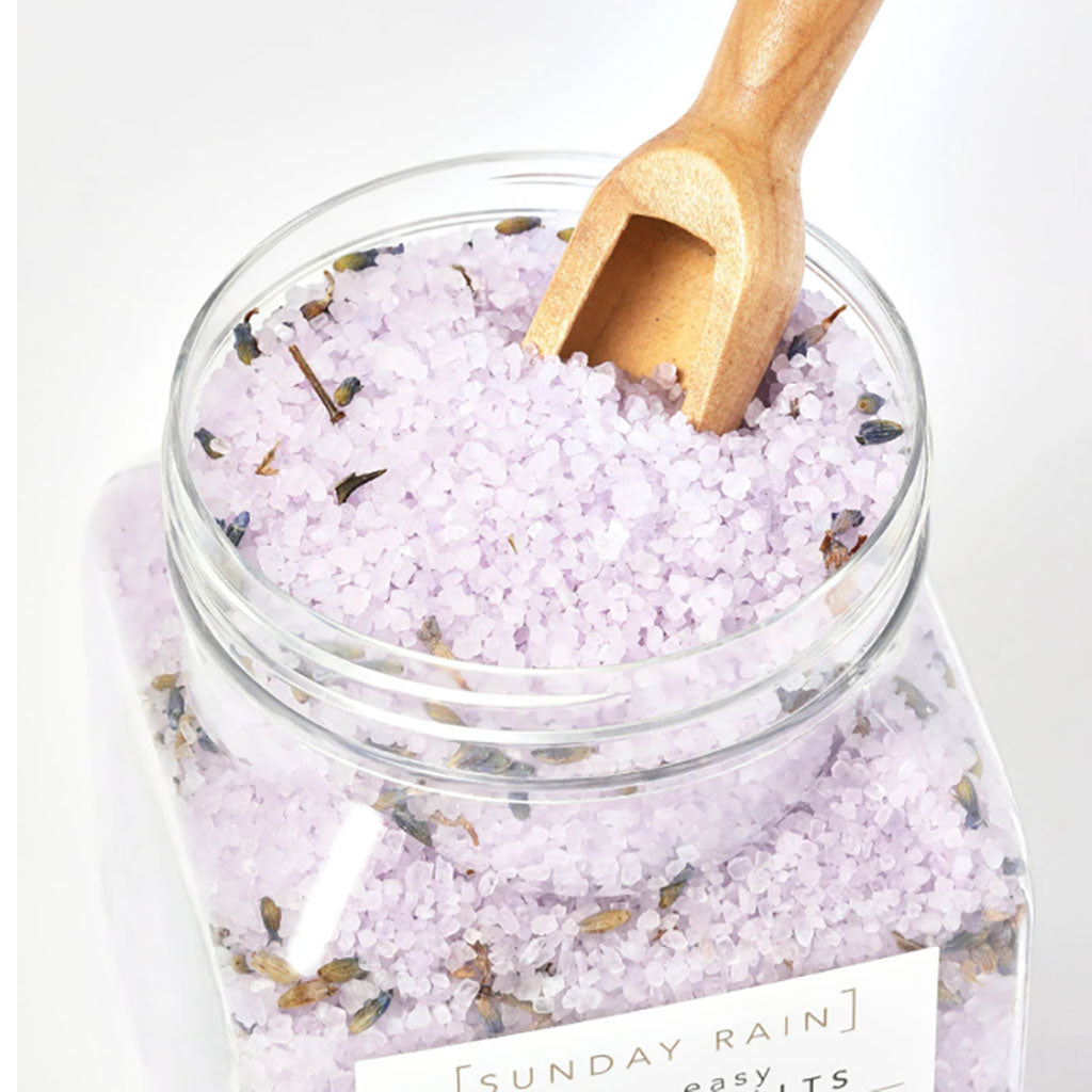 Sunday Rain Lavender and Cedarwood Sleep Easy bath crystals in a clear jar with lavender and cedarwood herbs, ideal for relaxing baths.