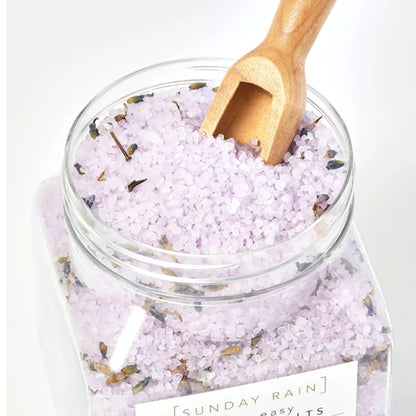 Sunday Rain Lavender and Cedarwood Sleep Easy bath crystals in a clear jar with lavender and cedarwood herbs, ideal for relaxing baths.
