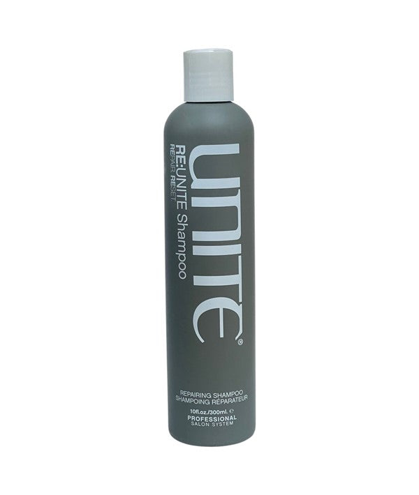 Unite Hair Re:Unite Repairing Shampoo bottle with label, featuring a sleek design and clear branding, on a neutral background.