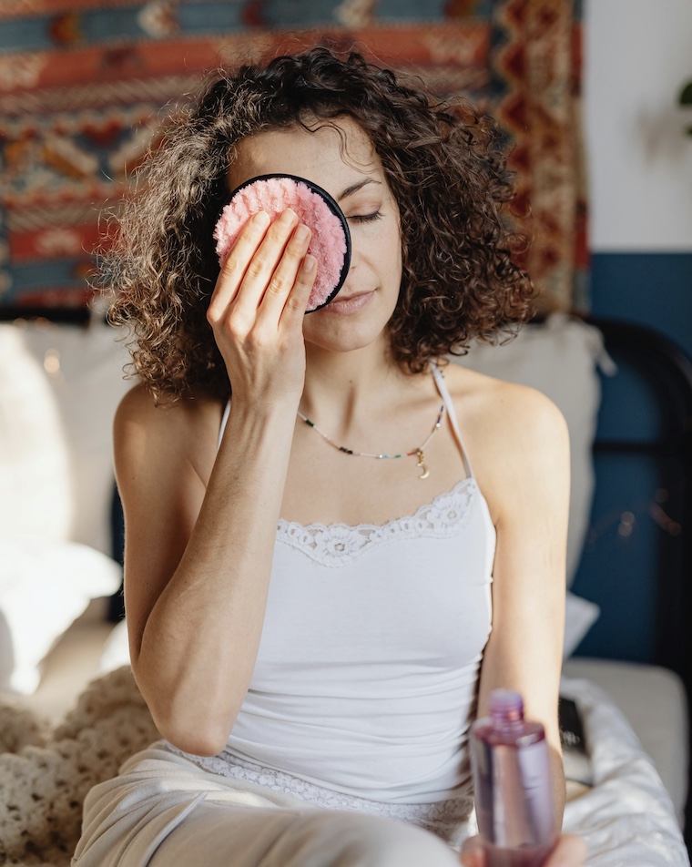 woman using makeup remover